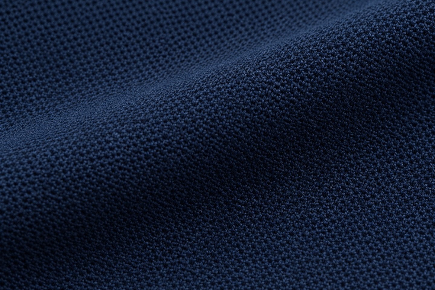 Navy pique fabric showing its textured knit surface